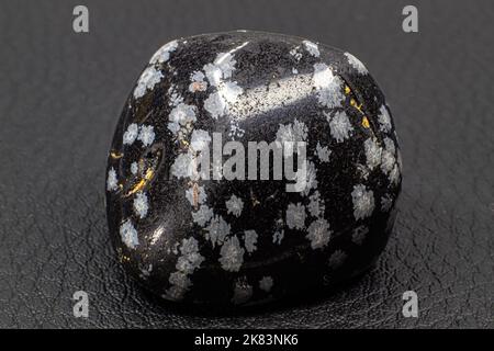 Tumbled close up snowflake obsidian isolated on white background Stock Photo
