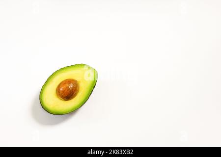 Avocado halves on a white background for healthy nutrition Stock Photo