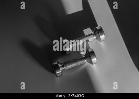 Close up of dumbbells on grey backgound. Sport and fitness equipment. Horizontal sport poster, greeting cards, headers, website. Stock Photo
