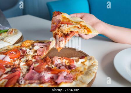 Italian pizza in a children's hand close-up Stock Photo