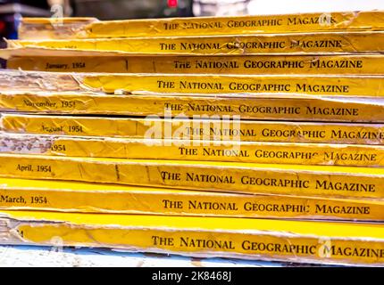 National Geographic magazines showing signs of wear, from 1954 stacked Stock Photo