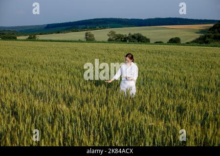 Laboratory-technician using digital tablet computer in a cultivated wheat field, application of modern technologies in agricultural activity. Stock Photo