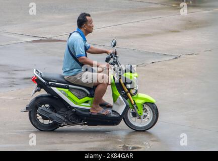 SAMUT PRAKAN, THAILAND, SEP 23 2022, A man with rides a motorcycle Stock Photo