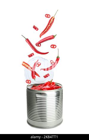 Open tin can with falling tasty chili peppers on white background Stock Photo