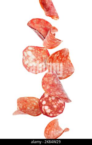 Flying slices of delicious salami isolated on white Stock Photo