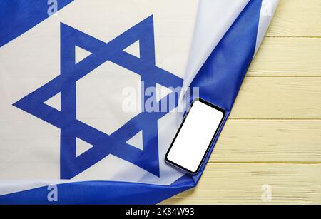 Flag of Israel and text SHABBAT SHALOM on wooden background Stock Photo