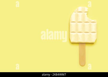 White chocolate bar and ice cream stick on color background Stock Photo