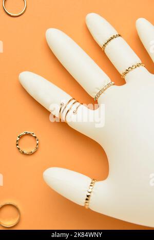 Inflated medical glove with stylish jewelry on color background, closeup Stock Photo