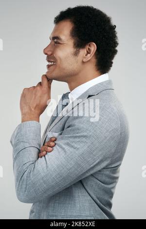 I always have a plan. Studio shot of a businessman looking thoughtful while standing against a grey background. Stock Photo