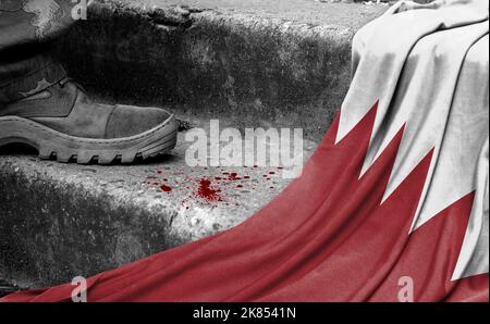 The leg of the military stands on the step next to the flag of Bahrain, the concept of military conflict Stock Photo