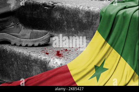 The leg of the military stands on the step next to the flag of Senegal, the concept of military conflict Stock Photo