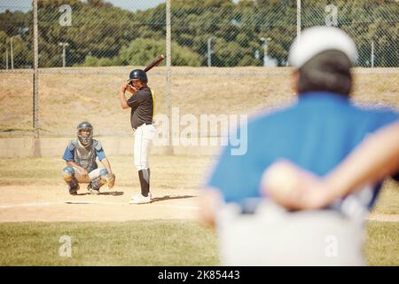 Team, baseball and pitch in sports game for exercise, collaboration and player with bat ready to hit ball. Teamwork, fitness and athletes on baseball Stock Photo