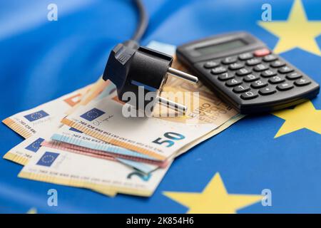 Electric plug and euro money on the european union flag. Concept of energy crisis. Stock Photo