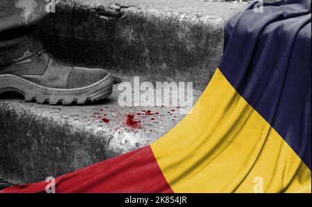 The leg of the military stands on the step next to the flag of Chad, the concept of military conflict Stock Photo