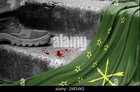 The leg of the military stands on the step next to the flag of Adygea, the concept of military conflict Stock Photo