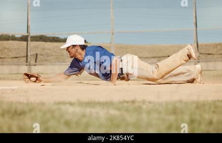 Sports, action and a man catching baseball, sliding in dust on floor with ball in baseball glove. Slide, dive and catch, baseball player on the ground Stock Photo