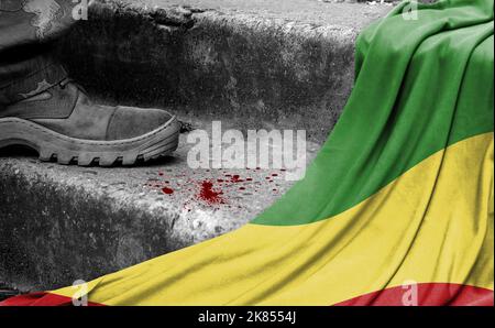 The leg of the military stands on the step next to the flag of Congo,Republic, the concept of military conflict Stock Photo