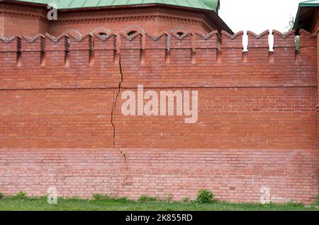 Long vertical crack in a red brick kremlin wall Stock Photo