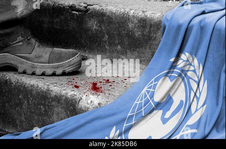 The leg of the military stands on the step next to the flag of United Nations Children's Fund, the concept of military conflict Stock Photo