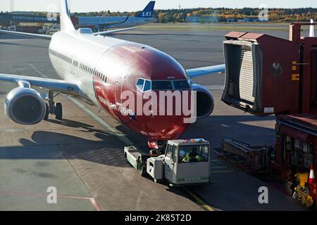 Stockholm, Arlanda Sweden - October 11, 2022: aircraft being towed to the disembarkation bridge Stock Photo