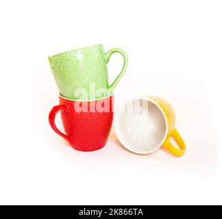 Three colorful mugs isolated on white background. Stock Photo