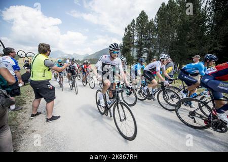 Team Sky's Wout Poels and Geraint Thomas take water bottles and energy gels over the Montee des Plateau des Giliers. Stock Photo