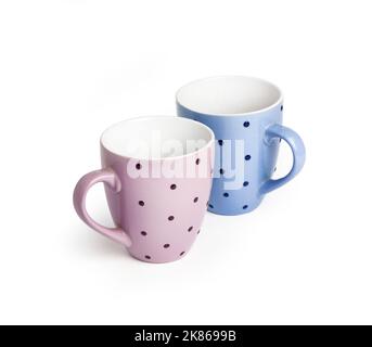 Pink and blue dotted mugs isolated on white background with clipping path. Copy space Stock Photo