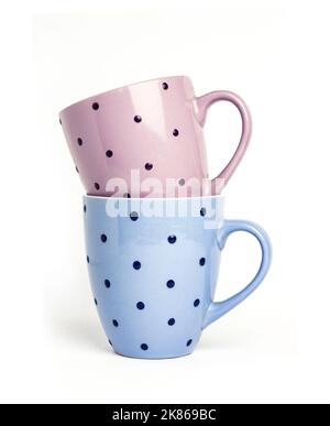 Two colorful dotted mugs isolated on white background Stock Photo