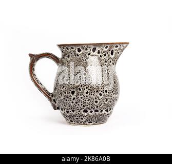 Glazed ceramic milk jar isolated on a white background Stock Photo