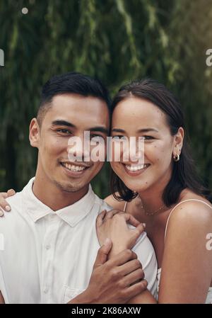 Were stronger when were together. a happy young couple standing close together outside during the day. Stock Photo
