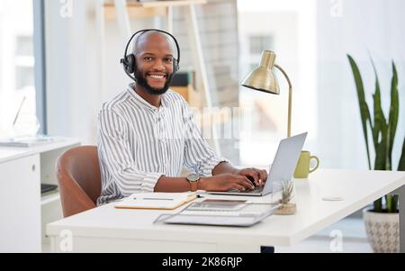 Working hard form the outset. a young businessman working in a call center. Stock Photo