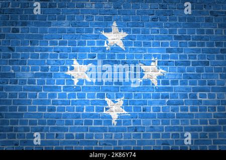 An image of the Micronesia flag painted on a brick wall in an urban location Stock Photo