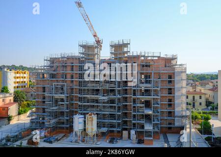 construction site with equipment and building. Skyscraper in construction close-up with a crane. Building construction site. Construction works Stock Photo