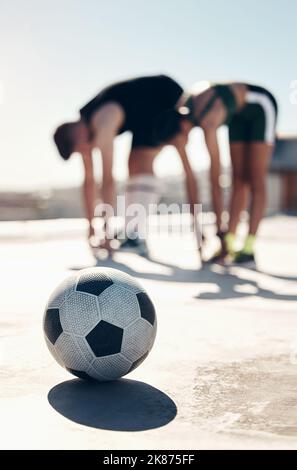 Soccer, stretching and people training in the city for professional event, competition and game. Athlete friends doing a warm up, cardio exercise and Stock Photo