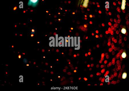 Red garlands on window. Lights in dark. Red lamps. Interior details. Red Light District. Stock Photo