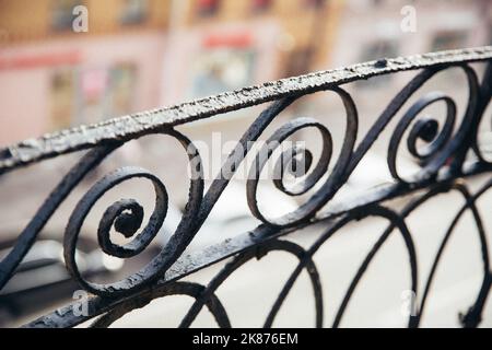 Summer veranda on second floor of country house. Fencing of terrace with curly lattice. Back wall is made of facing bricks. Garden furniture. Table Stock Photo