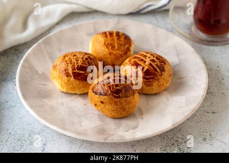 Turkish little pogaca. Traditional flavors. Pogaca on gray background. close up Stock Photo