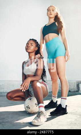 Fitness, friends and soccer ball portrait of athlete women in city for sports training and street soccer. Football, workout and healthy girl Stock Photo