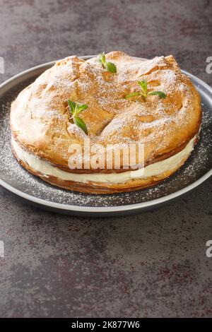 Polish Carpathian Mountain Cream Cake Karpatka closeup on the plate on the table. Vertical Stock Photo