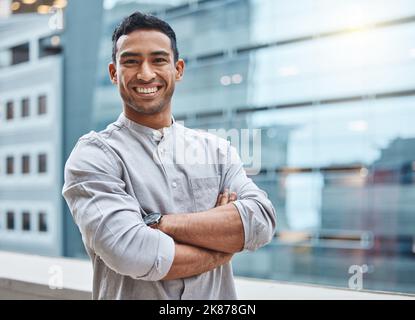 Confidence will get you anywhere. Portrait of a confident young businessman standing against an urban background. Stock Photo