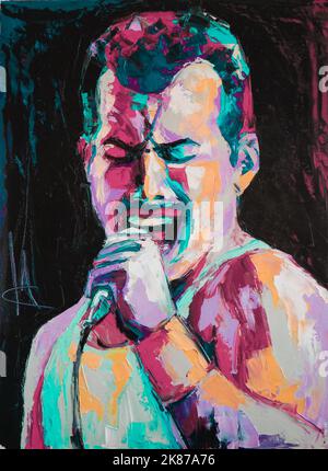 Oil portrait painting in multicolored tones. Portrait of singing Freddie Mercury. Conceptual closeup of an oil painting and palette knife on canvas. Stock Photo