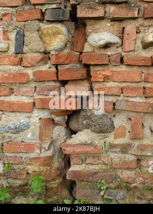 Old and cracked brick wall  background closeup Stock Photo