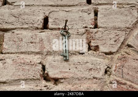 Old brick wall painted and bunch of keys Stock Photo