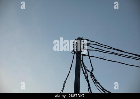 Electrical wires on pole. Many wires against sky. High voltage pole. Stock Photo
