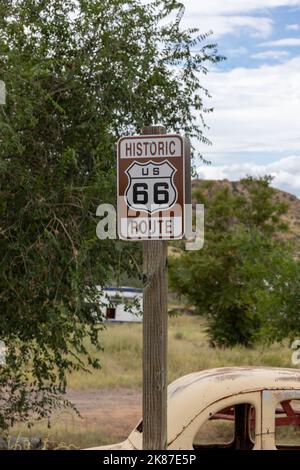 A route 66 sign posted on the side of the highway on America's historic east-west route. Stock Photo