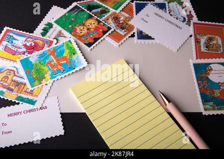 envelope on the table with a postcard and stamps Stock Photo