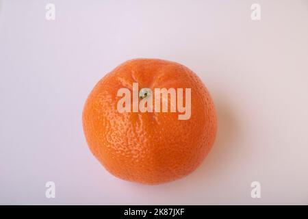 one tangerine is on the table Stock Photo