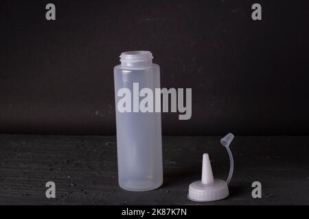 plastic sauce bottle on a black background Stock Photo