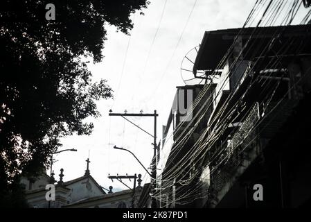 Salvador, Bahia, Brazil - December 12, 2021: Utility pole among houses and trees in Rio Vermelho neighborhood. Stock Photo