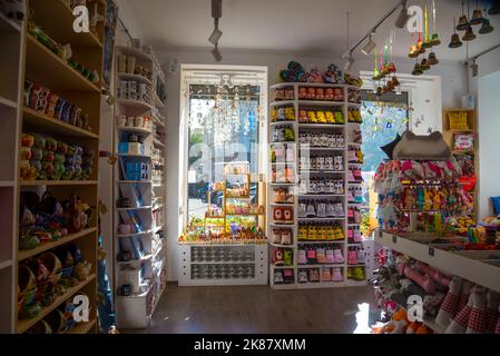 Lviv, UA - 10, 06, 2018: Interior of souvenir shop in Lviv Old Town. National clothes, embroidery, toys and souvenirs, paintings, antiques and much mo Stock Photo